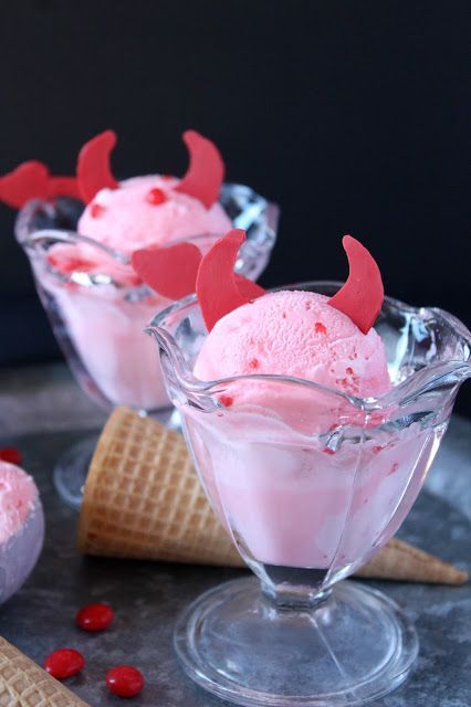 three ice creams in small glass dishes with red decorations