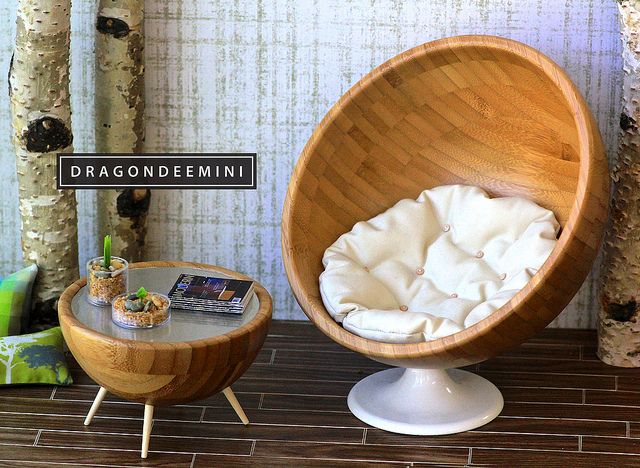 an egg chair and side table in front of birch trees with the name dragondemin on it