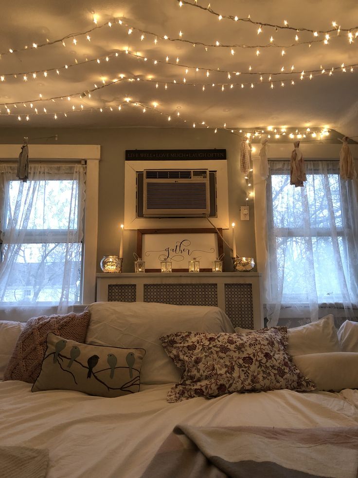 a bedroom with lights strung from the ceiling