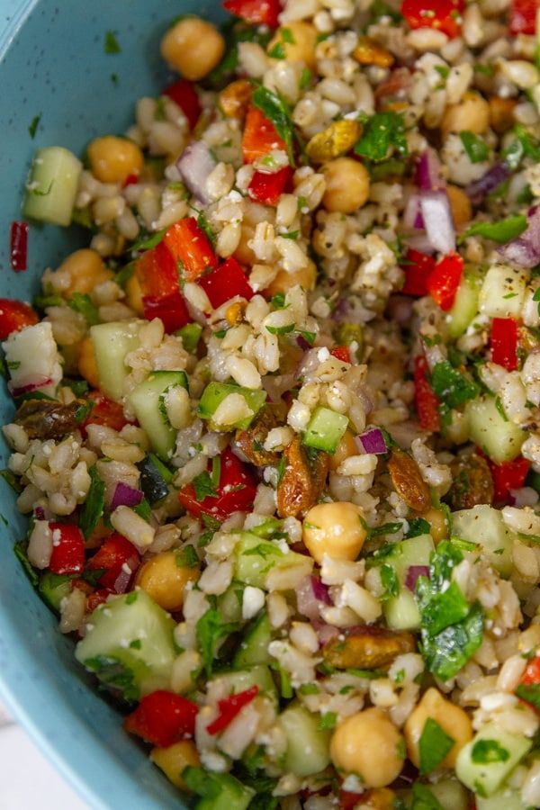 a blue bowl filled with rice and vegetables