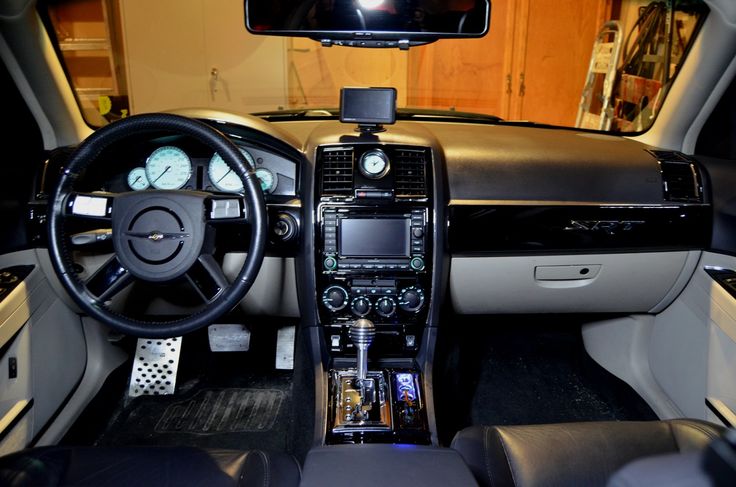 the interior of a car with dashboard, steering wheel and dash lights on display in a showroom