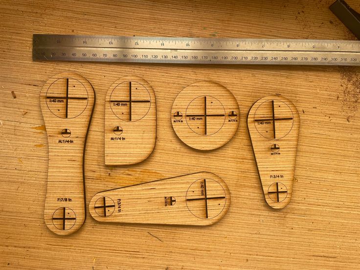 four wooden rulers are laid out on a table