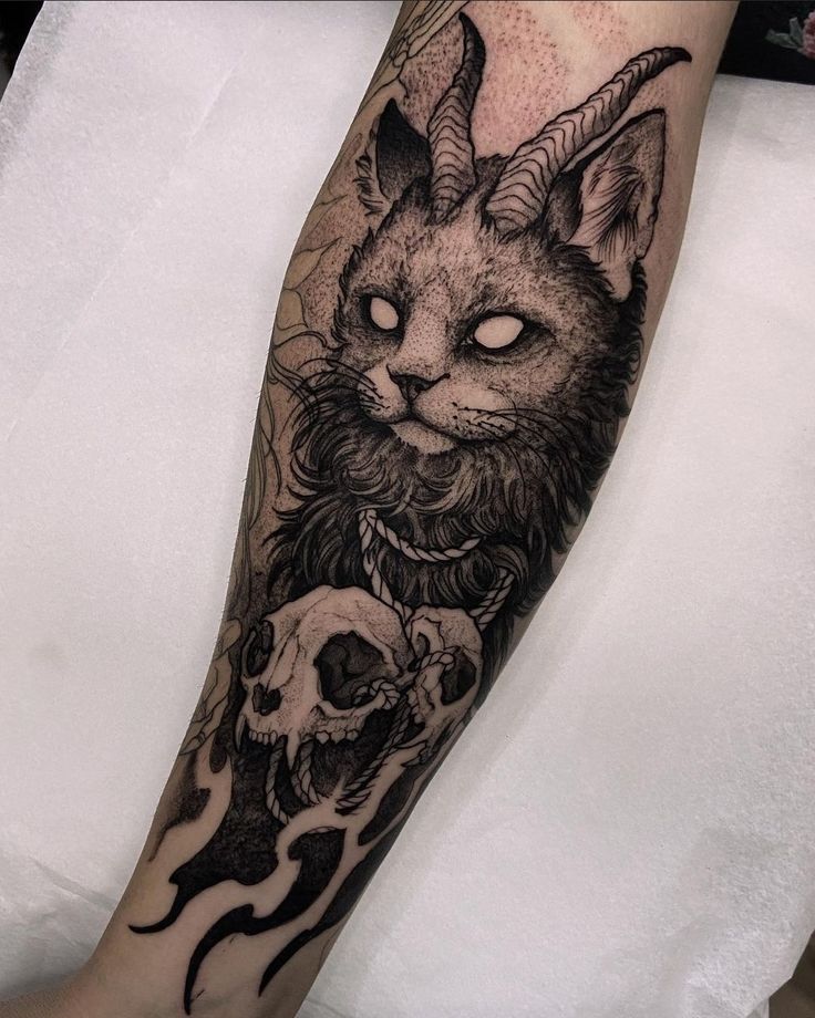 a cat with horns and skulls on its leg