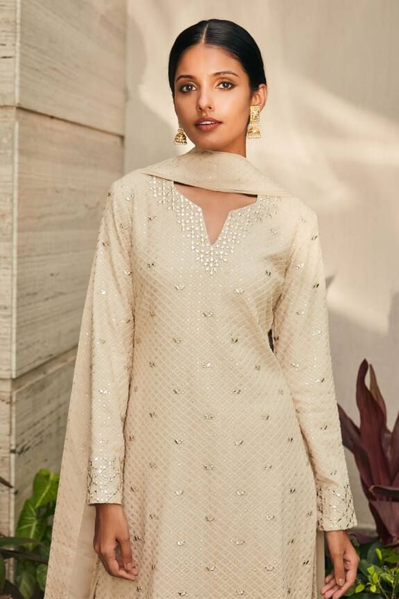 Beige georgette kurta with chikankari and mirror embroidery. Comes with salwar and a dupatta.
Components: 3
Pattern: Embroidered
Type Of Work: Chikankari, Mirror
Neckline: Notched
Sleeve Type: Full
Fabric: Georgette
Color: Beige
Other Details: 
Model Height : 5 ft 7 inches, wearing size XS
Occasion: Sangeet - Aza Fashions Georgette Kurta, Mirror Embroidery, Types Of Work, Set For Women, Aza Fashion, Model Height, Sleeve Type, Types Of Sleeves, Embroidery