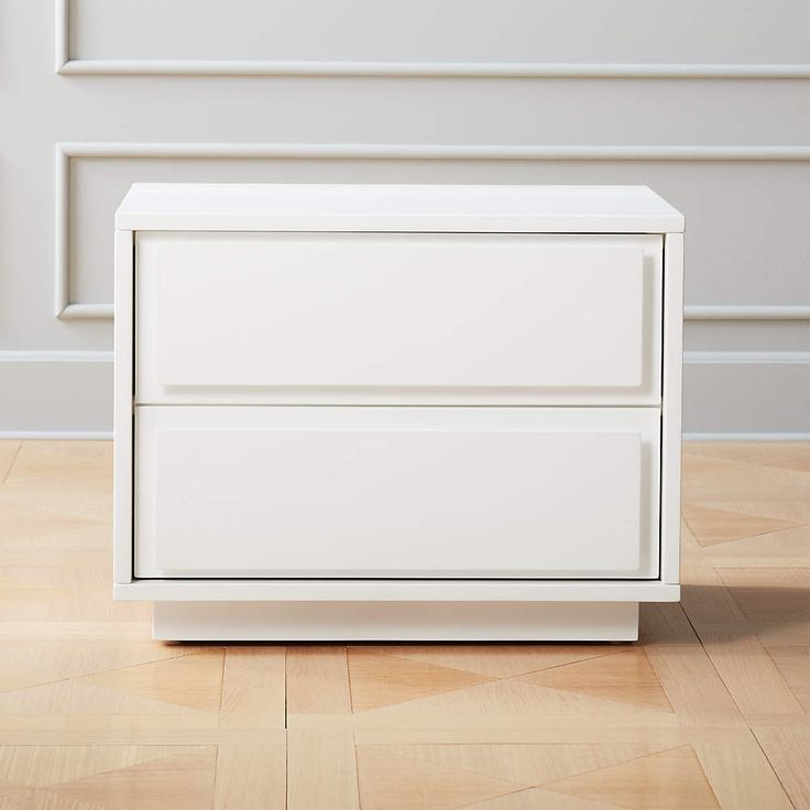 a white dresser sitting on top of a hard wood floor