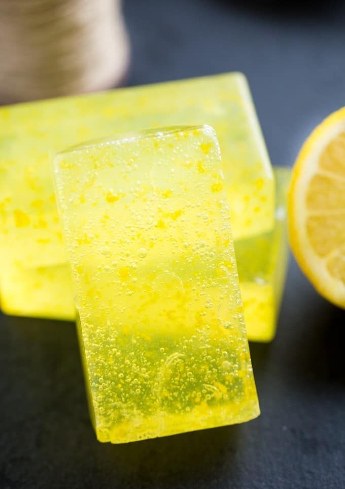 two pieces of yellow soap sitting next to an orange