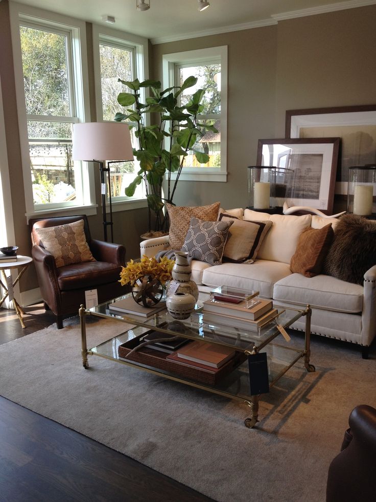 a living room filled with furniture and a large plant in the middle of the room