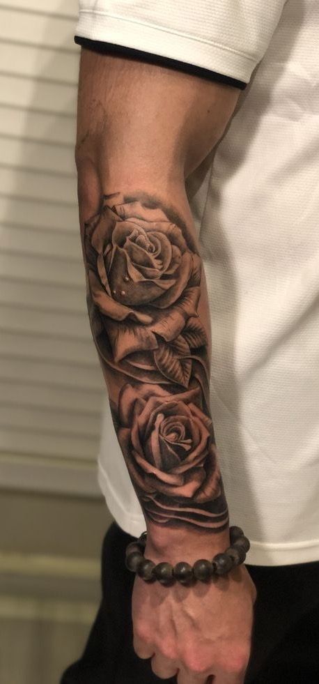 a man with a rose tattoo on his arm