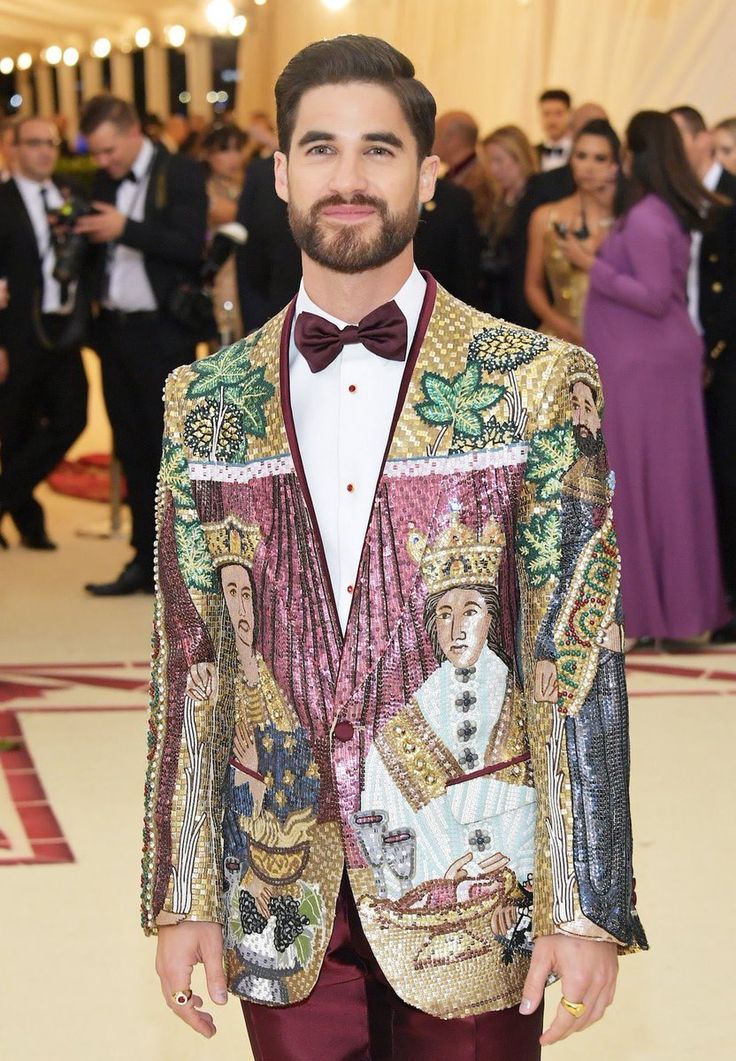 a man in a colorful suit and bow tie