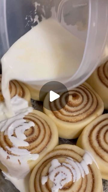 cinnamon rolls being made in a blender with white icing on top and frosting drizzled over them