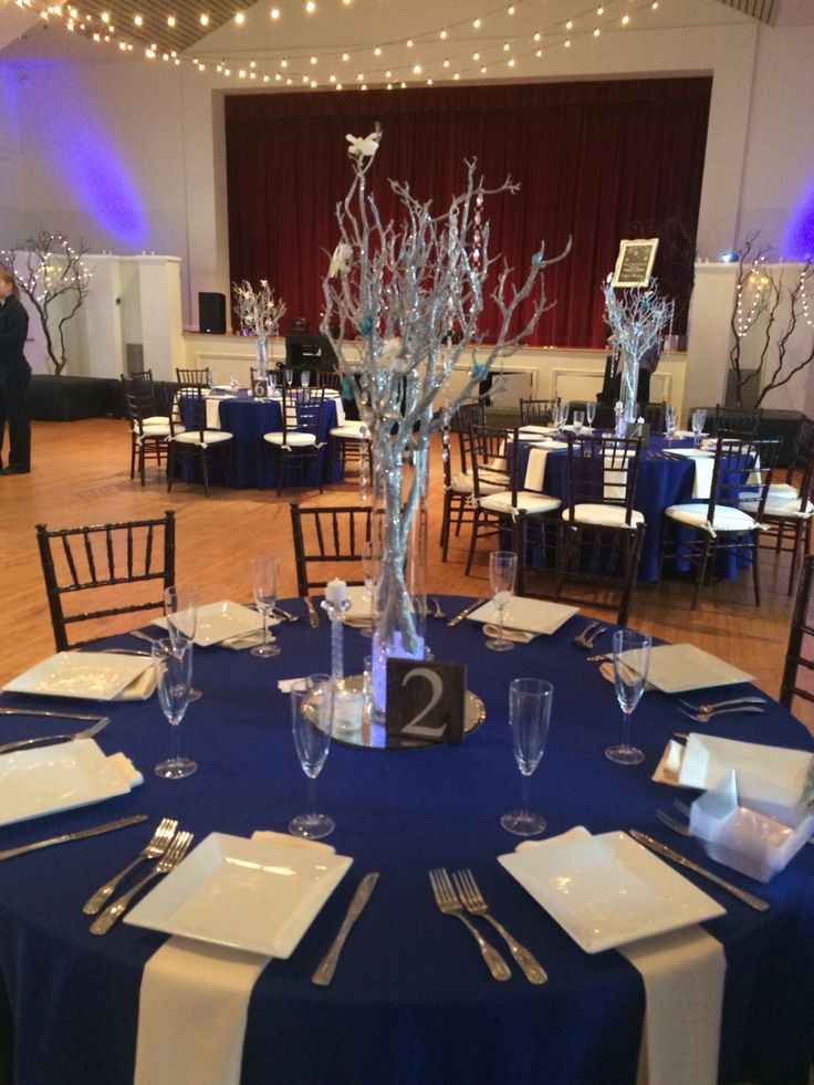 a table set up with place settings and centerpieces