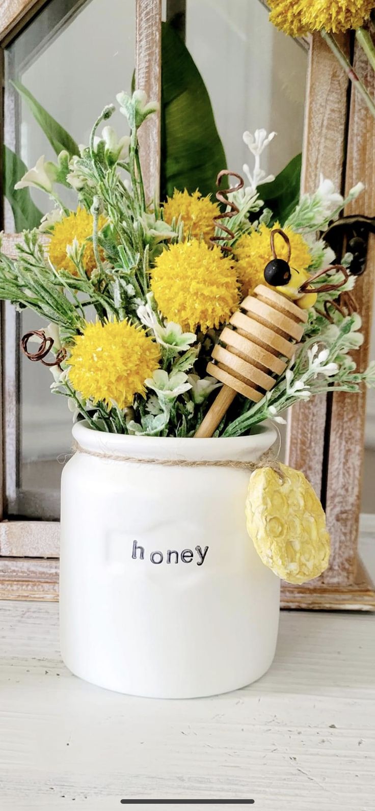 a vase filled with yellow flowers sitting on top of a table