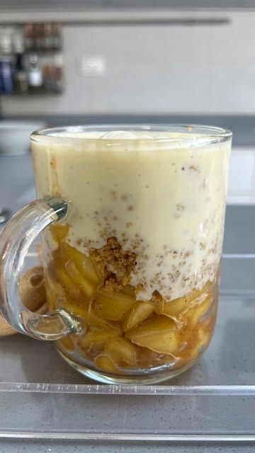 a glass mug filled with food sitting on top of a counter