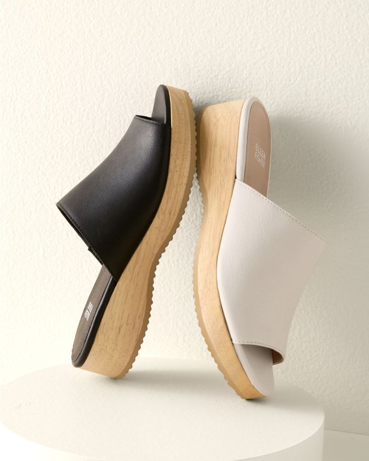 A casual slide in rich leather with a slight wedge, for an everyday slip-on that's a touch above the rest. Well crafted with comfy padding and a sustainable-wood base.  By EILEEN FISHER. Leather-wrapped padded footbed. Wood wedge and platform. Man-made sole. Spring Everyday Clogs With Cushioned Footbed, Spring Clogs With Cushioned Footbed For Everyday, Spring Leather Footbed Clogs For Everyday, Modern Slide Clogs With Leather Footbed, Modern Leather Footbed Slide Clogs, Spring Comfortable Platform Slippers With Leather Footbed, Comfortable Leather Footbed Platform Slippers For Spring, Comfortable Cushioned Wedge Heel Slides, Modern Leather Footbed Slides With Wedge Heel