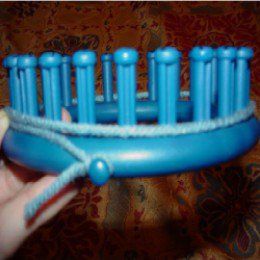 a person is holding a blue toothbrush holder