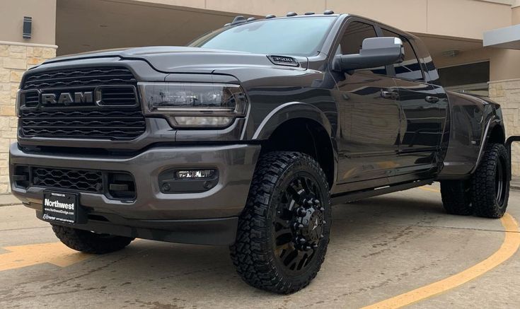 a large gray truck parked in front of a building