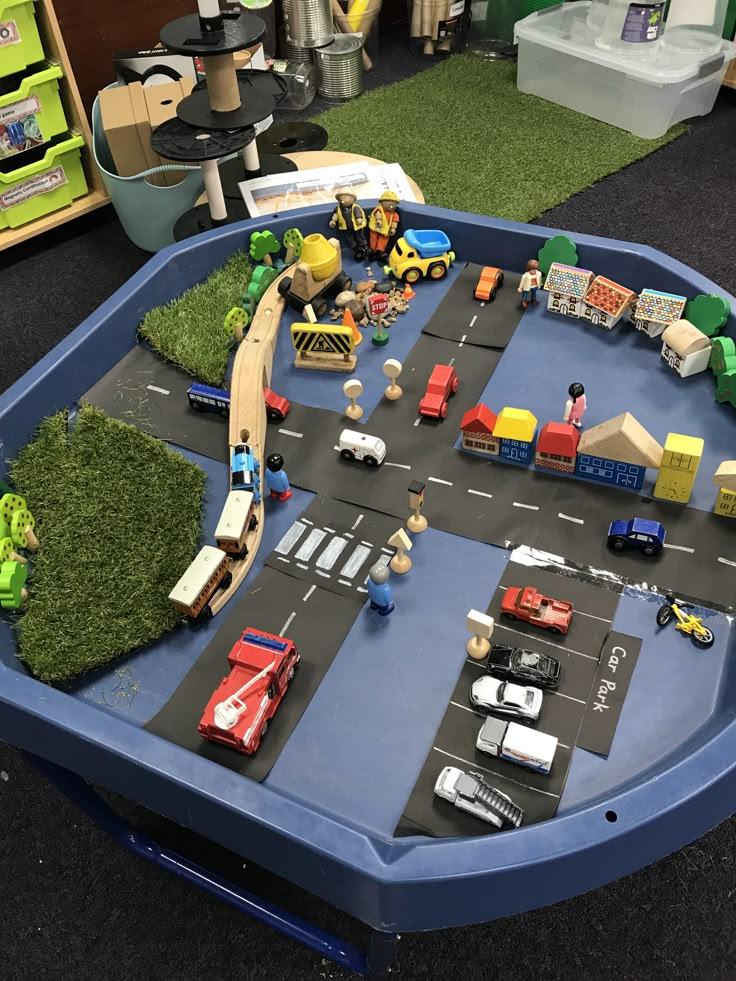 toy cars and trucks are on the play table