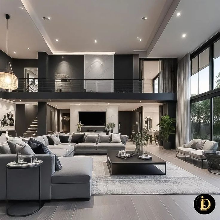 a large living room with high ceilings and lots of windows on the wall, along with modern furniture