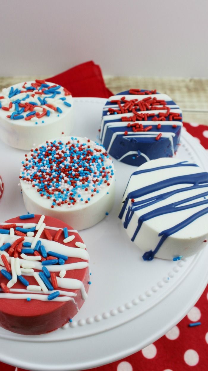 red, white and blue cupcakes with sprinkles on a plate