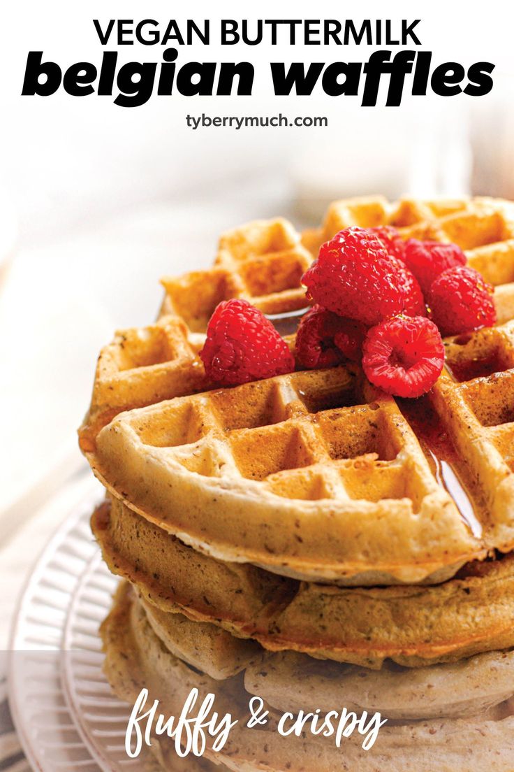 a stack of waffles with raspberries on top and the words vegan buttermilk belgian waffles