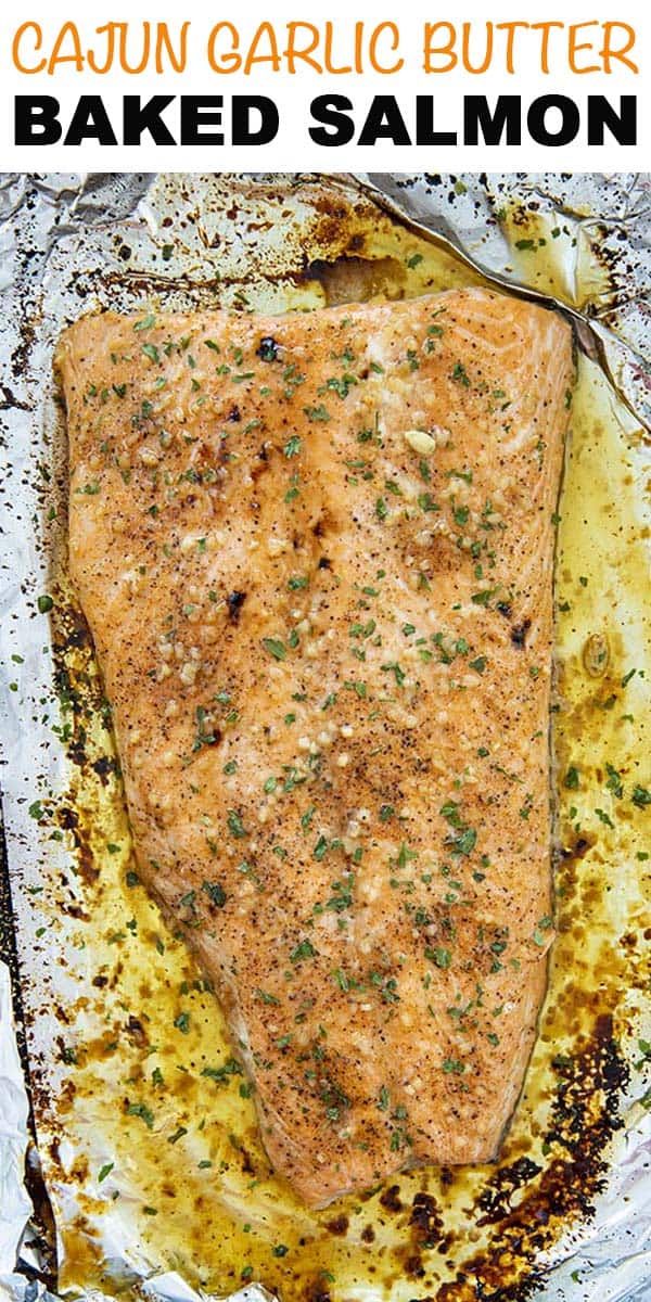 an image of baked salmon on foil with text overlay that reads cajun garlic butter baked salmon