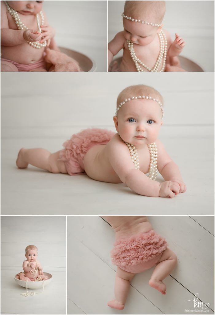 a baby girl wearing pearls in her diaper