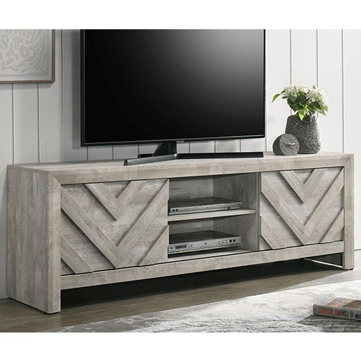 an entertainment center with a flat screen tv mounted on it's sideboard in a living room