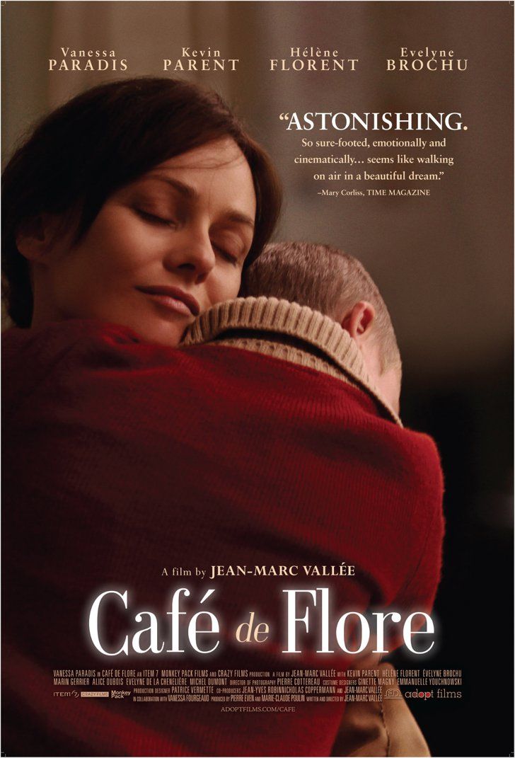 a woman holding a baby in her arms with the words cafe de flore on it