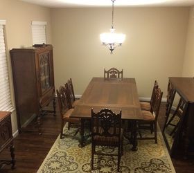 a dinning room table with chairs and a rug on the floor