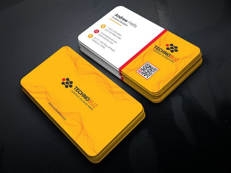 two yellow business cards sitting on top of a table