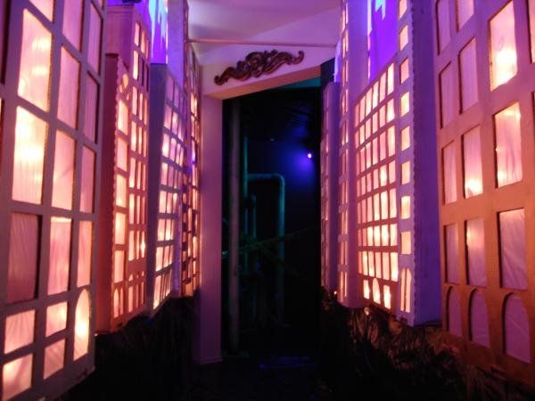 an open door leading into a room with purple lights on the walls and windows in it