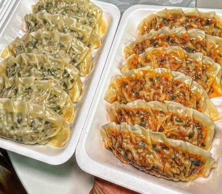 two trays filled with different types of food on top of a table next to each other