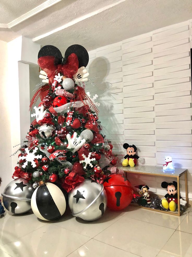 a christmas tree decorated with mickey mouse ornaments