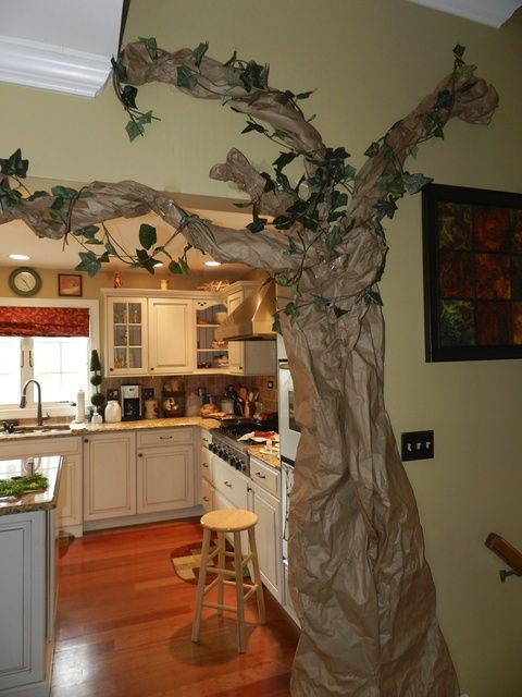 an image of a tree in the middle of a kitchen that is decorated with paper