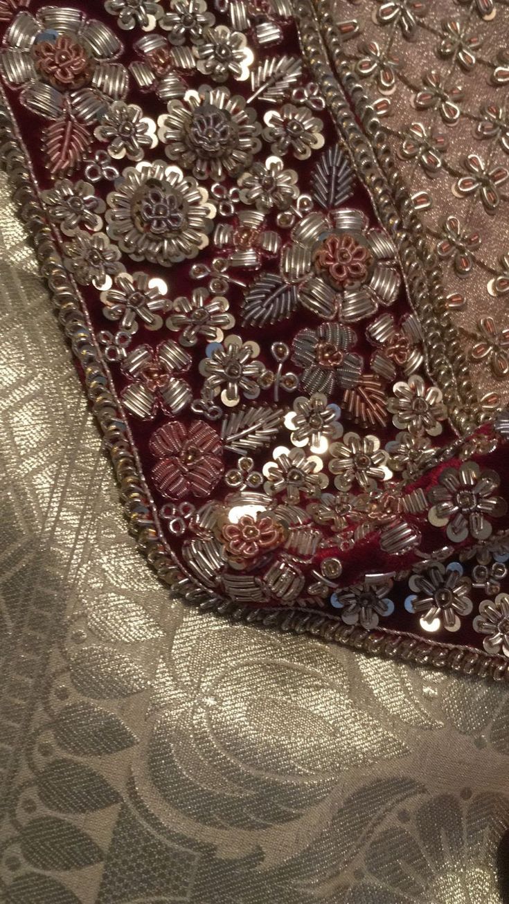 two pieces of cloth with beading on them are laying next to each other,