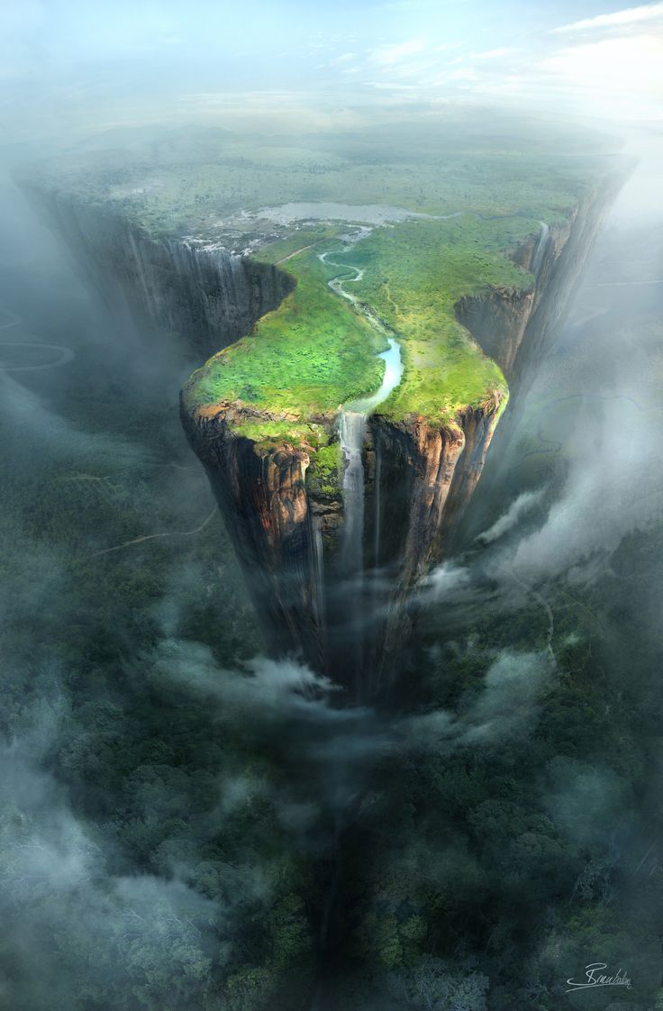 an aerial view of a waterfall surrounded by clouds