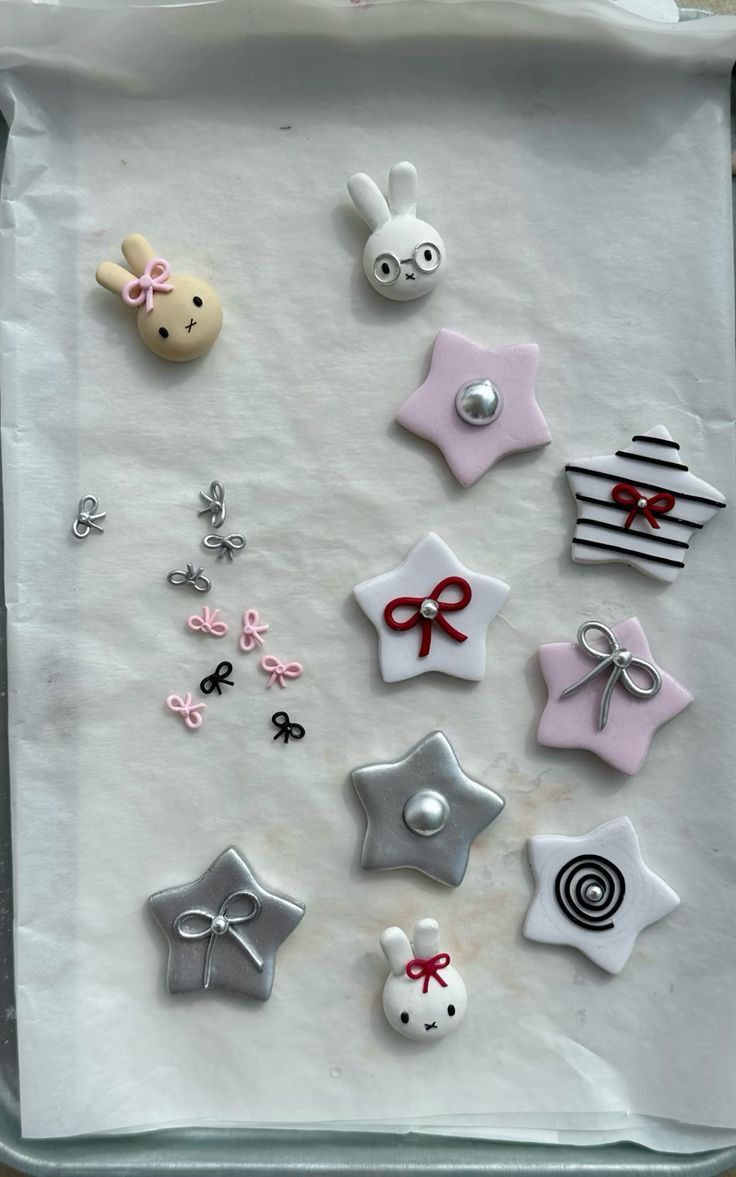 a tray filled with lots of different types of buttons on top of white parchment paper