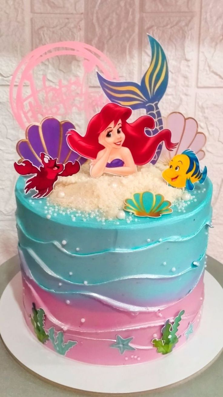 the little mermaid cake is decorated with fondant