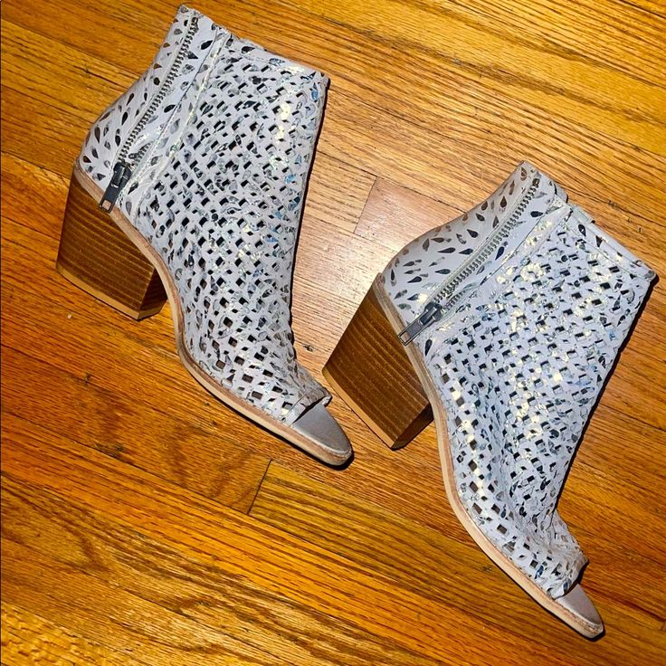 Leather. Brand New. Leather Perforated Design. Silver Accents. Working Zippers On Each Side Of Boot. Low Block Heel - Super Comfortable! Brand Is Silent D But Purchased At Anthropologie. Silver Ankle Boot Heels For Fall, Casual Silver High Heels, Silver Casual Closed Toe Heels, Casual Silver Closed Toe Heels, Silver Ankle-high Heels For Spring, Metallic Silver Round Toe Heels For Spring, Silver Casual Heels For Spring, Casual Silver Heels For Spring, Spring Silver Ankle Boot Heels