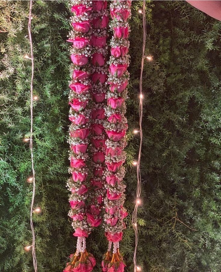 pink flowers and lights hanging from the ceiling