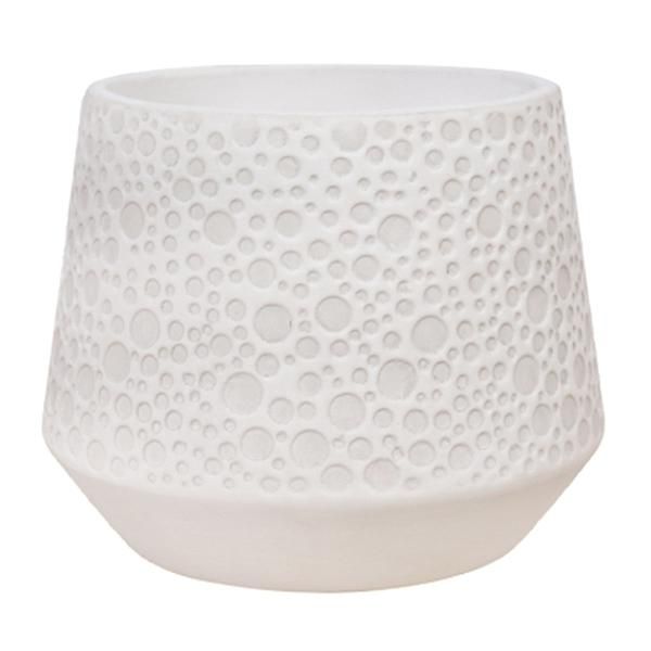 a white vase with holes on it