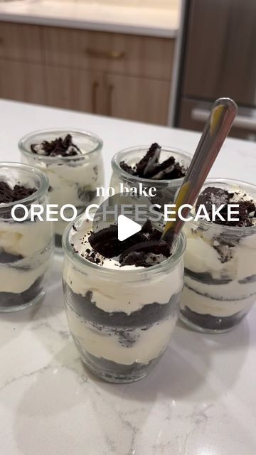 four desserts in small glass jars on a counter top with the words oreo cheesecake