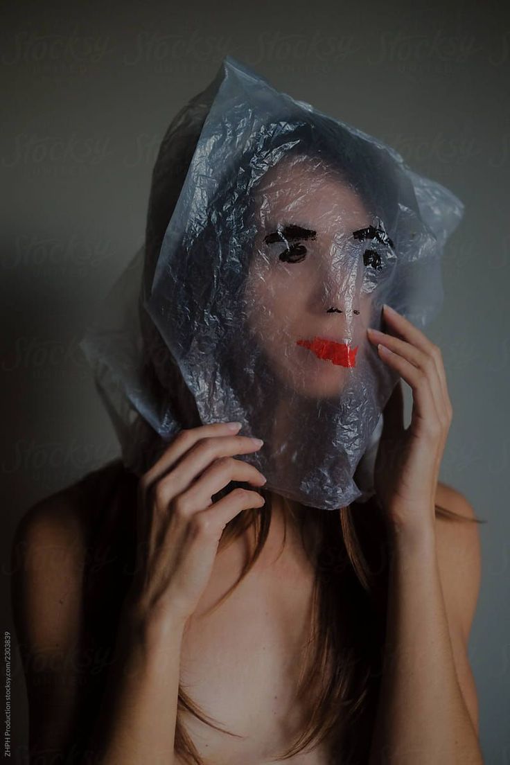 a woman wearing a plastic sheet covering her face with red lipstick on the lips and nose