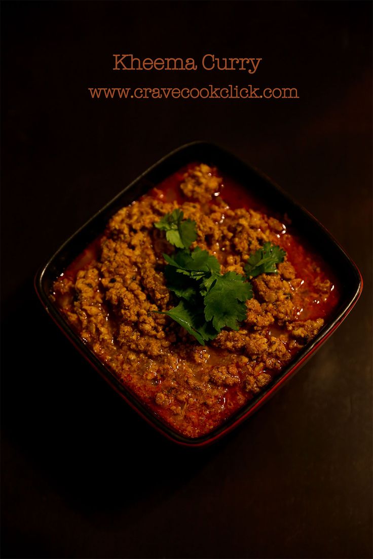 a bowl filled with chili and cilantro on top of a table