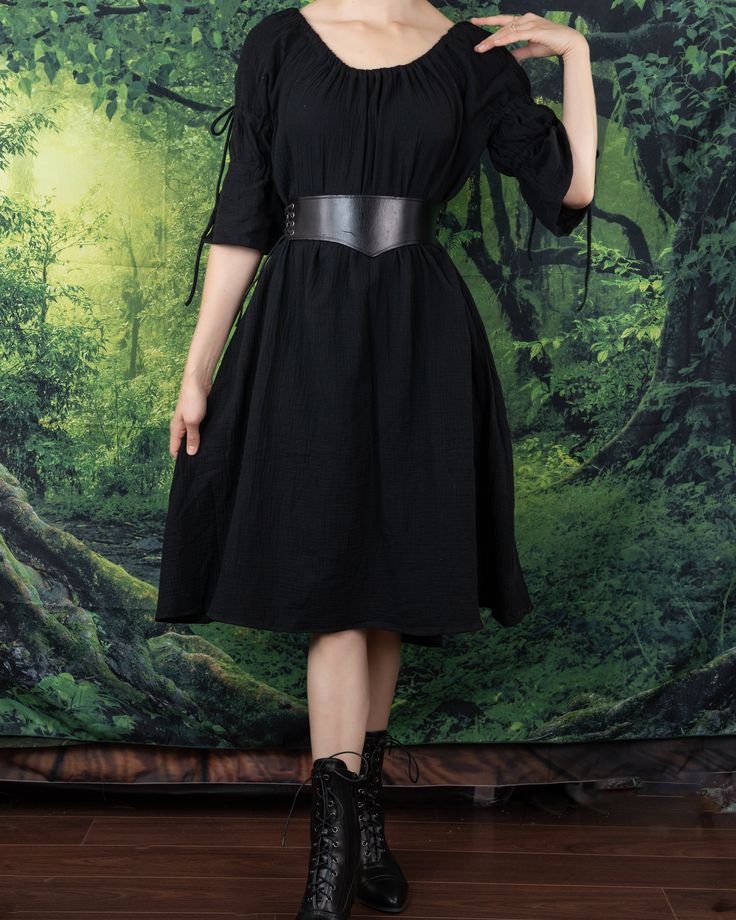 A timeless and ever-flattering classic, our Black Cotton Puff Sleeve Chemise makes the perfect dress to wear on it's own, under a corset, or accessorized with your favorite renaissance faire accessories. This dress is made from super soft 100% textured cotton fabric, featuring puff sleeves and an optional on or off the shoulder silhouette. Adjustable ties above the elbow create two voluminous puffs in the sleeves, and an elastic neckline keeps our chemise snug and fitted around your shoulders and arms. This listing is for the black dress only, other items in these photos can be purchased separately from our shop. Medieval Dresses For Fantasy Events, Medieval Style Dress For Costume Party, Elegant Dresses With Historical Design For Larp, Elegant Historical Design Dress For Larp, Peasant Dresses For Medieval Festivals, Fall Cosplay Corset Dress, Elegant Corset Dress With Historical Design, Elegant Underbust Corset Belt For Cosplay, Medieval Corset Dress Costume