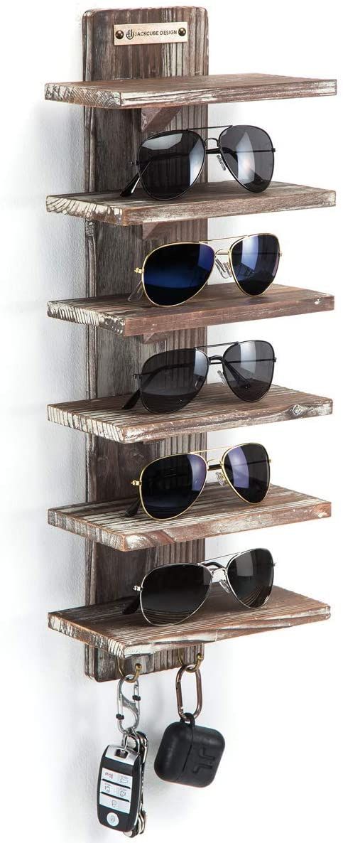 a wooden shelf with sunglasses and keys hanging from it