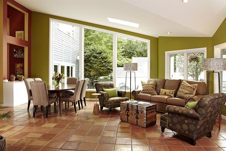 a living room filled with furniture and lots of windows