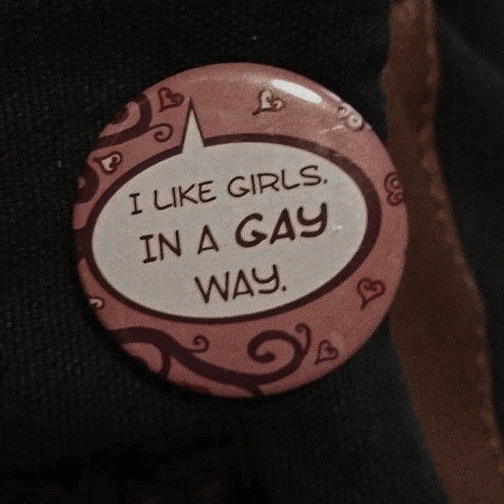 a button that says i like girls in a gay way on the back of someone's shirt