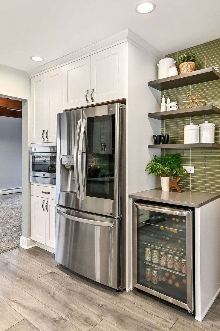 a kitchen with stainless steel appliances and white cabinets