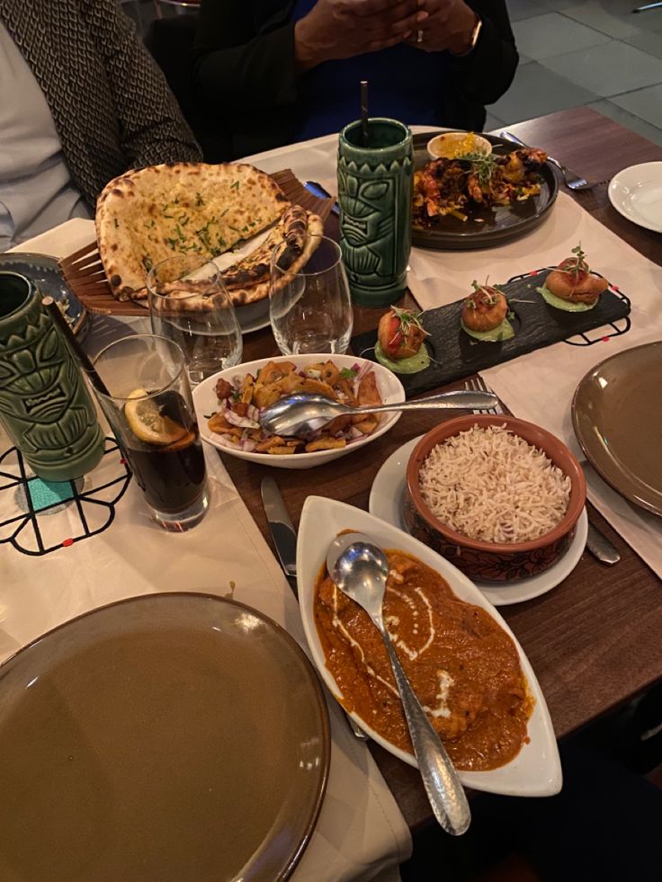 a table filled with plates and bowls of food